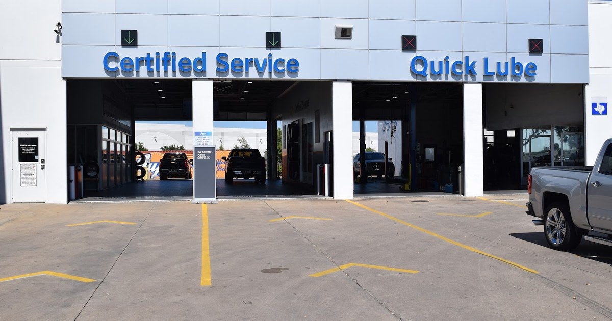 Certified Service and Quick Lube entrance at Jupiter Chevrolet in Garland, TX with service bays open