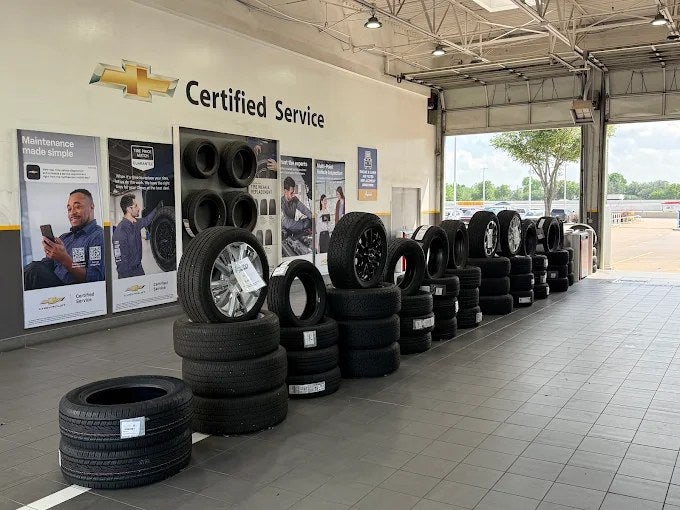 Tire display under Chevrolet Certified Service signage at Jupiter Chevrolet in Garland, TX