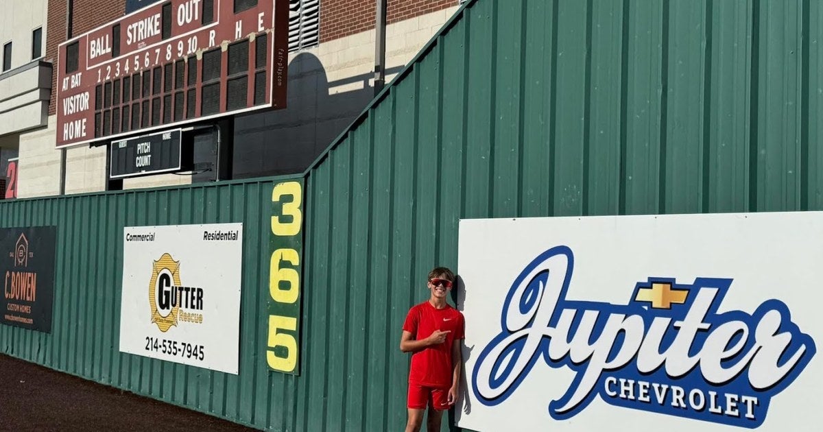 Jupiter Chevrolet outfield wall sponsor sign at a local high school baseball field
