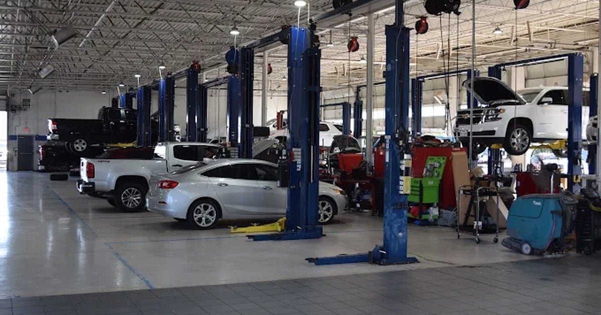 Chevrolet vehicles on lifts in the Jupiter Chevrolet service department in Garland, TX