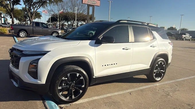 White Chevrolet Equinox on the lot at Jupiter Chevrolet in Garland, Texas, with the Jupiter sign behind it