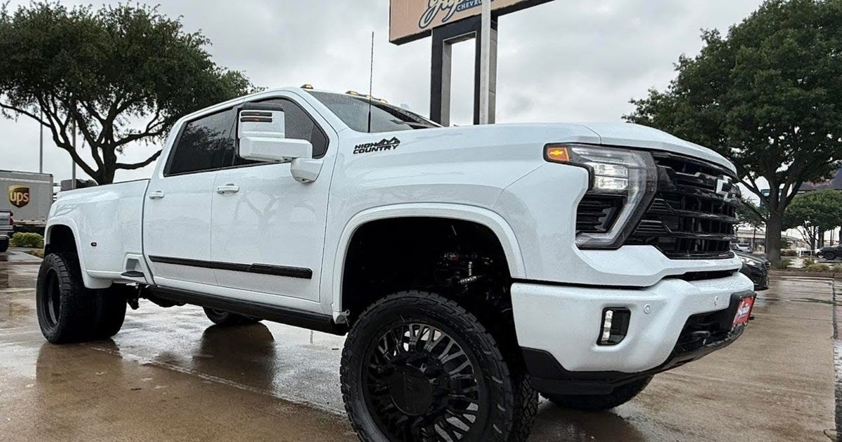 Lifted white Chevrolet Silverado High Country dually custom build on aftermarket wheels at Jupiter Chevrolet in Garland, TX